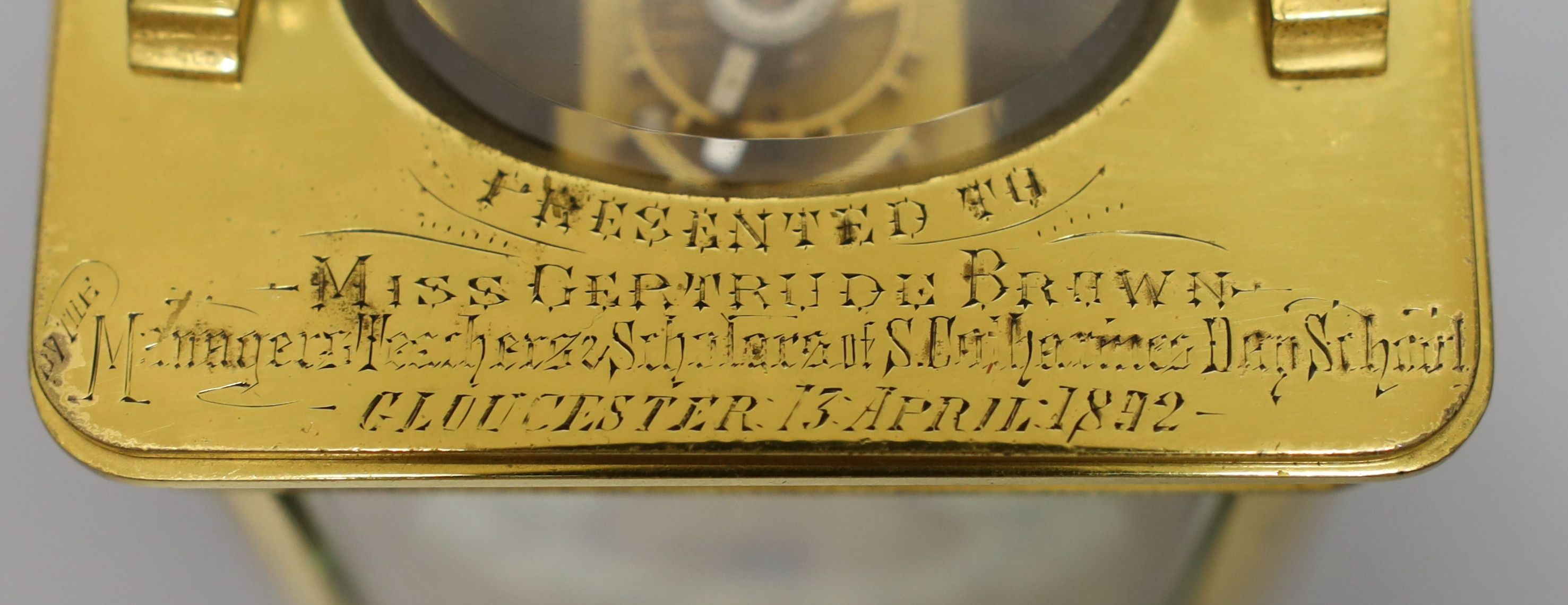 A cased French gilt brass carriage timepiece with relief cast dial and engraved presentation inscription - 14cm tall